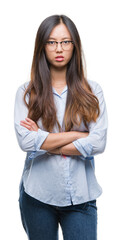 Young asian business woman wearing glasses over isolated background skeptic and nervous, disapproving expression on face with crossed arms. Negative person.