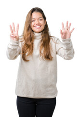 Young beautiful brunette woman wearing turtleneck sweater over isolated background showing and pointing up with fingers number eight while smiling confident and happy.