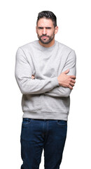 Fototapeta premium Young handsome man wearing sweatshirt over isolated background skeptic and nervous, disapproving expression on face with crossed arms. Negative person.