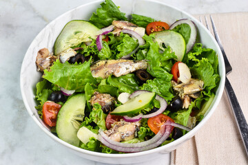 fresh garden salad top with sardines