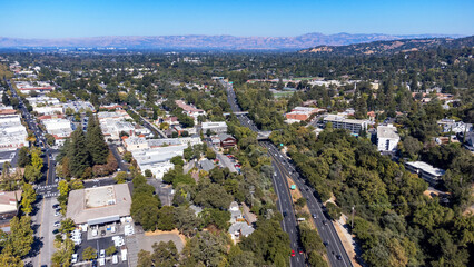 Highway 17 cuts through Downtown Los Gatos, California, surrounded by a blend of commercial buildings, residential neighborhoods, and trees