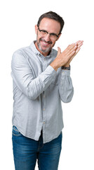 Fototapeta premium Handsome middle age elegant senior man wearing glasses over isolated background Clapping and applauding happy and joyful, smiling proud hands together
