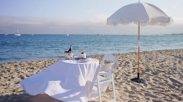 Imagine a serene beach with a lovely table under a charming umbrella, creating an enchanting atmosphere for couples to share meaningful moments while enjoying a tranquil ocean backdrop
