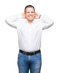 Fototapeta premium Middle age arab elegant man over isolated background Relaxing and stretching with arms and hands behind head and neck, smiling happy