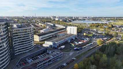 Obraz premium Minsk, Belarus - 27.10.2024: The outskirts of Minsk in the fall, a large metropolis, a view from a height. The area behind the ring road of Minsk. Storage warehouses, repair depots, private buildings.