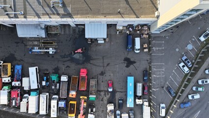 Repair base of a large trucking company from a bird's eye view vertically downward. Repair of trucks, buses, tractors, loaders. Service station for construction and industrial machinery.