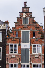 Colorful old buildings with gable rooftops and hooks along Herengracht canal. In XVII century richest merchants, most influential regents and mayors lived on this canal. Amsterdam, the Netherlands.