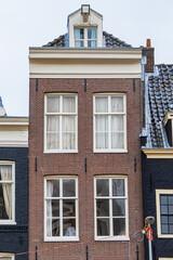 Colorful old buildings with gable rooftops and hooks along Herengracht canal. In XVII century richest merchants, most influential regents and mayors lived on this canal. Amsterdam, the Netherlands.