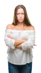 Young caucasian beautiful woman over isolated background skeptic and nervous, disapproving expression on face with crossed arms. Negative person.