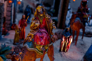 King Kaspar riding a camel advances towards the Nativity scene. Painting, concept Christmas and...