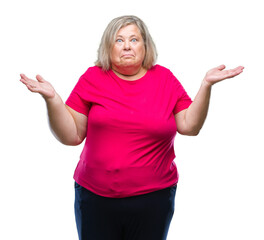 Senior plus size caucasian woman over isolated background clueless and confused expression with arms and hands raised. Doubt concept.