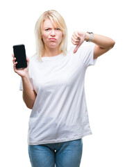 Fototapeta premium Young beautiful blonde woman showing screen of smartphone over isolated background with angry face, negative sign showing dislike with thumbs down, rejection concept