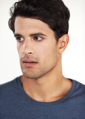 Obraz premium Man, thinking and cool in studio with fashion, casual style and confidence isolated on white background. Student, face and contemplating, pride and positive expression with trendy outfit or clothes