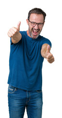 Handsome middle age hoary senior man wearin glasses over isolated background approving doing positive gesture with hand, thumbs up smiling and happy for success. Looking at the camera, winner gesture.