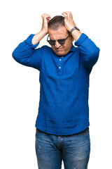 Fototapeta premium Middle age arab man wearing sunglasses over isolated background suffering from headache desperate and stressed because pain and migraine. Hands on head.