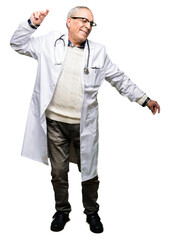 Fototapeta premium Handsome senior doctor man wearing medical coat Dancing happy and cheerful, smiling moving casual and confident listening to music