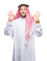 Young handsome man wearing keffiyeh over isolated background relax and smiling with eyes closed doing meditation gesture with fingers. Yoga concept.