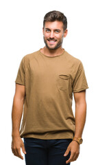 Obraz premium Young handsome man over isolated background looking away to side with smile on face, natural expression. Laughing confident.