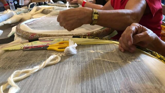 Embroidery skills involve decorating cloth with threads and needlework on indigenous pineapple textile.close up