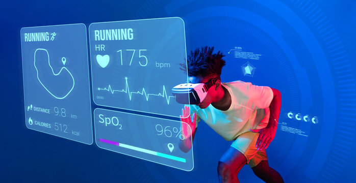 African man jogging or using augmented reality goggle and artificial intelligence practicing and training. Male model with shirt doing running posture and looking at hologram. Technology. Ingenuity.