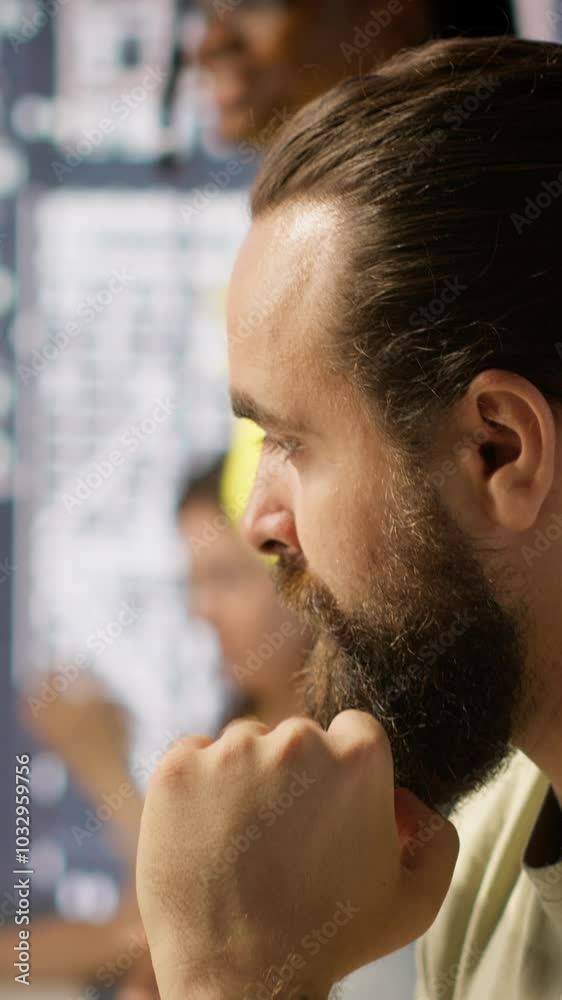 Poster vertical video pensive employee using computer to analyze datasets, focused on comparing datasets an