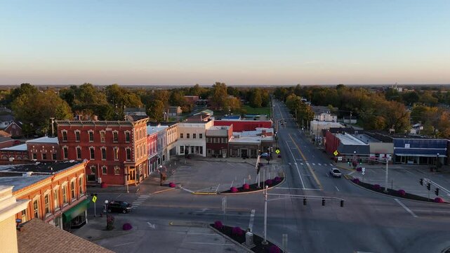 A drone view over the downtown square of Lancaster, Kentucky, gradually pulling back to showcase the historic courthouse tower.