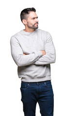 Fototapeta premium Young handsome man wearing sweatshirt over isolated background smiling looking to the side with arms crossed convinced and confident