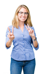 Beautiful young business woman over isolated background smiling looking to the camera showing fingers doing victory sign. Number two.