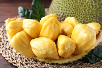Fresh exotic jackfruit bulbs on wooden table, closeup