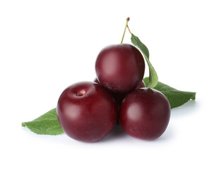 Ripe plums with leaves isolated on white