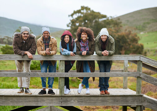 Friends, bridge and outdoor portrait in nature, autumn holiday and countryside for bonding. Happy people, diversity and weekend on boardwalk in woods, vacation and together on trip to Costa Rica