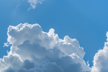 Fluffy white clouds in a bright blue sky. Outdoor nature photography. Weather and sky concept.