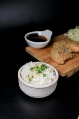 Japanese tonkatsu fried pork cutlet recipe with sweet sour sauce and rice on wooden broad. Asian food.