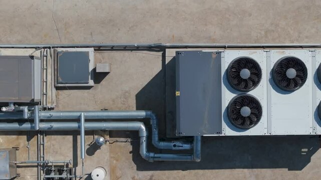 air conditioning industrial in top of a building roof, ac unit and pipe tubes with ventilation fans