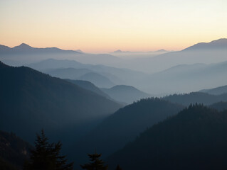 Obraz premium A serene mountain landscape with a mist-covered forest at dawn