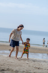 Mother playing with son on the beach