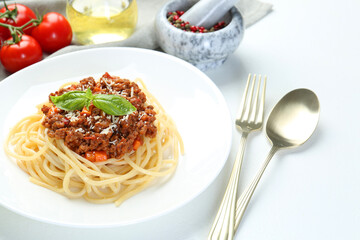 Delicious pasta bolognese served on white table