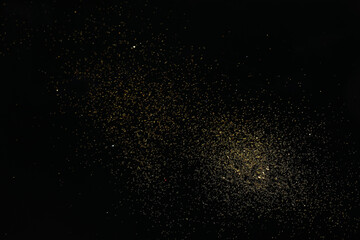 Beautiful shiny golden glitter on black background, top view