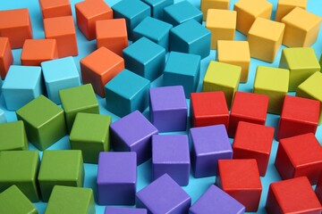 Many colorful cubes on light blue background