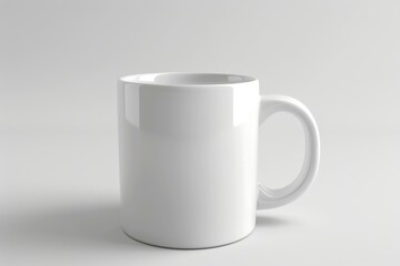Obraz premium A white ceramic mug with a handle sits on a white background.