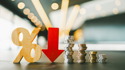 Percentage model, coin stack and down arrow, concepts for success, methods, systems of raising or lowering Fed interest rates to correct inflation concepts.