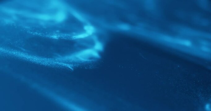Blue abstract particle effect with flowing motion, resembling underwater or cosmic scenes. Ideal for video loops, technology, sci-fi, relaxation, and motion graphics.