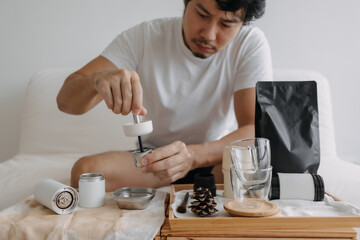 Step by step of Asian man making espresso with hand press tools.