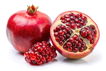 ripe pomegranate seeds and split pomegranate on white background