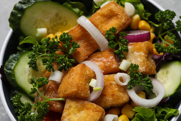 Fried tofu salad in a bowl close-up