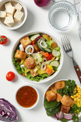 Fried tofu salad with vegetables and sauce top view