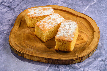 Traditional Sponge Cakes on Rustic Wooden Plate