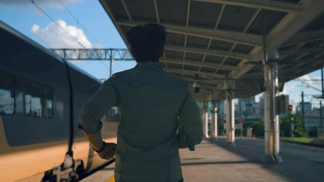 Man Traveler Running to Catch Departing Train at Railway Seoul Station. Rear View of Passenger Missed Train Running after Departed KTX Train