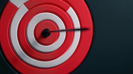 A close-up view of a red and white target, with an arrow pointing towards the center, symbolizing focus and goal achievement.