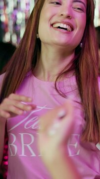 Bridal party, woman and bridesmaid dancing at nightclub for prewedding celebration, night out and social event. Bachelorette shower, person and energy on dancefloor with get together for bride to be